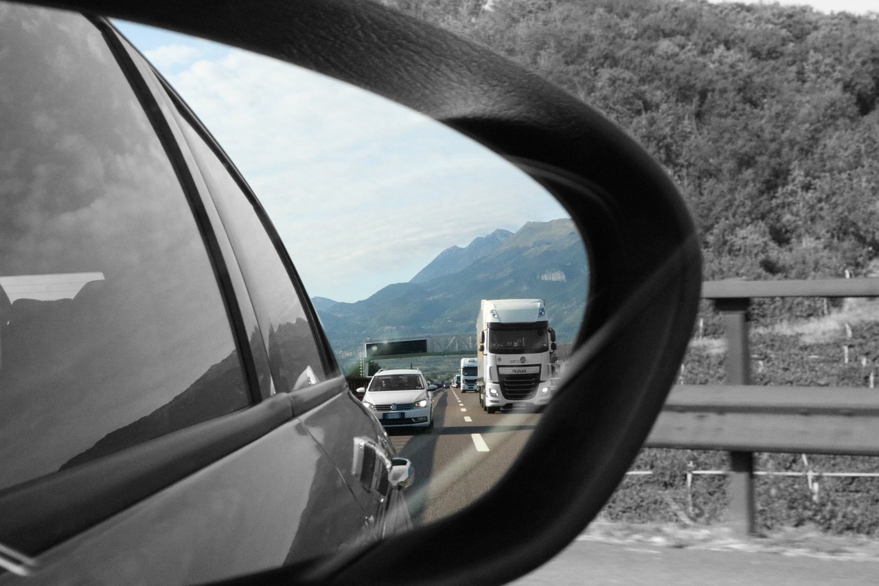 car mirror car mirror showing mountains and vehicles behind